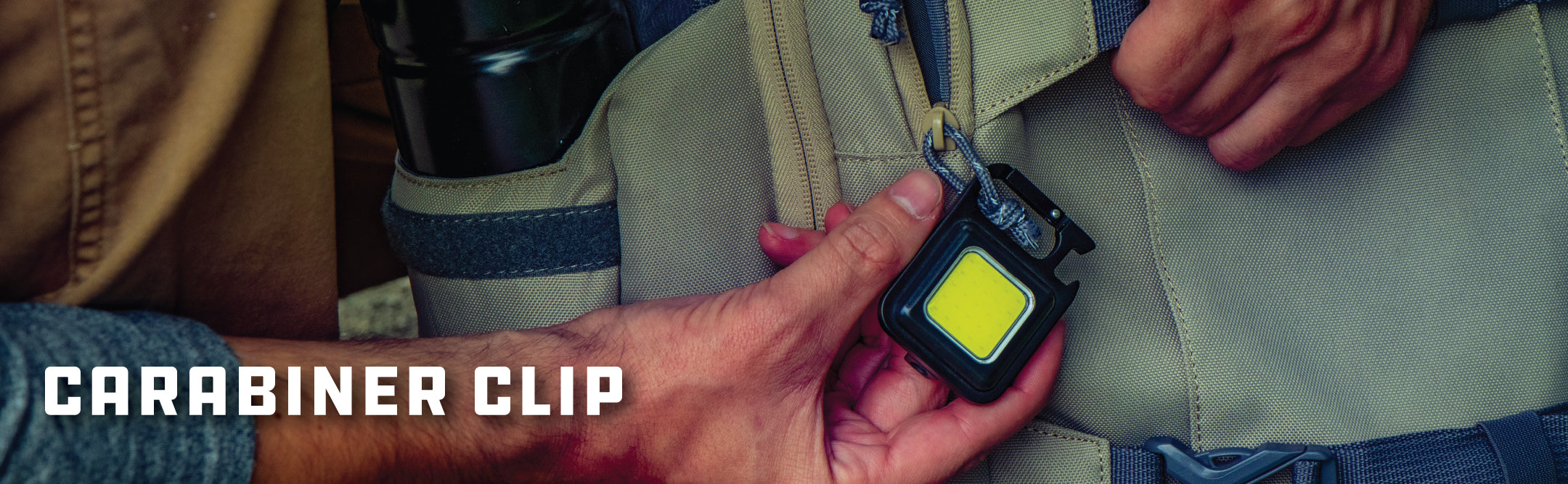 Kodiak Kompanion Compact Work Light Showing the Integrated Carabiner Being Attached To a Backpack